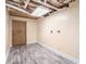 Unfinished basement area with wood-look flooring, a door, and an exposed ceiling at 1855 Mountain Trce, Canton, GA 30114