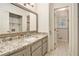 Modern bathroom with granite countertop, large framed mirror, and an open doorway to the toilet room at 1855 Mountain Trce, Canton, GA 30114