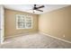 Bright bedroom with ceiling fan, plush carpet, and a window offering scenic views at 1855 Mountain Trce, Canton, GA 30114