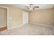 Bright, carpeted bedroom with ample space, a ceiling fan, and a closet with white bi-fold doors at 1855 Mountain Trce, Canton, GA 30114