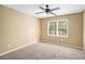 Cozy bedroom with a ceiling fan, plush carpet, and a bright window at 1855 Mountain Trce, Canton, GA 30114