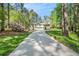 Inviting home with a long driveway surrounded by mature trees and lush greenery at 1855 Mountain Trce, Canton, GA 30114