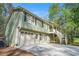 Charming home with attached garage and covered porch, surrounded by lush greenery at 1855 Mountain Trce, Canton, GA 30114