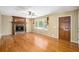 Inviting living room with a stone fireplace, hardwood floors, and natural light at 1855 Mountain Trce, Canton, GA 30114
