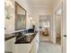 Well-lit bathroom featuring granite countertops with view to Primary bedroom and walk-in closet at 2550 Ballantrae Cir, Cumming, GA 30041