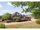 Charming brick home with lush landscaping and a well-manicured lawn, nestled under a bright, partly cloudy sky at 2550 Ballantrae Cir, Cumming, GA 30041