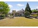 Well-manicured front yard with lush green lawn, mature landscaping and a charming building exterior at 2550 Ballantrae Cir, Cumming, GA 30041