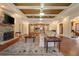 Spacious living room with hardwood floors, fireplace, coffered ceiling, and neutral tones at 2550 Ballantrae Cir, Cumming, GA 30041