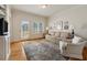 Inviting living room with hardwood floors, a plush sofa, and a door to a patio at 2550 Ballantrae Cir, Cumming, GA 30041