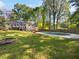 Spacious backyard features a large in-ground pool, lush greenery, mature trees, and a wood deck at 325 Summertown Dr, Stockbridge, GA 30281