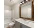 Bathroom featuring updated vanity, framed mirror, and shower-tub combo at 325 Summertown Dr, Stockbridge, GA 30281