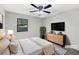 Cozy bedroom with neutral walls, a ceiling fan, and view to the outdoors at 325 Summertown Dr, Stockbridge, GA 30281