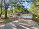 Charming ranch-style home with a covered front porch, mature trees, and a two-car garage at 325 Summertown Dr, Stockbridge, GA 30281