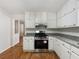 Modern kitchen boasting white cabinets, granite countertops, and stainless steel stove at 325 Summertown Dr, Stockbridge, GA 30281