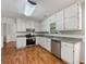 Well-lit kitchen featuring white cabinets, stainless steel appliances, and granite countertops at 325 Summertown Dr, Stockbridge, GA 30281