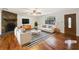 Bright living room with a stone fireplace, hardwood floors, and modern furnishings at 325 Summertown Dr, Stockbridge, GA 30281