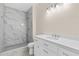 Bathroom with tile shower, modern vanity and fixtures at 5224 W Mountain St, Stone Mountain, GA 30083