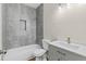 Bathroom with tiled shower, modern vanity, and updated fixtures at 5224 W Mountain St, Stone Mountain, GA 30083