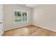 Sunlit bedroom features hardwood floors, neutral walls, and a large window with views at 5224 W Mountain St, Stone Mountain, GA 30083