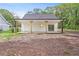 Exterior with porch featuring wooden posts and a yard with dirt at 5224 W Mountain St, Stone Mountain, GA 30083