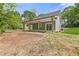 The home features a covered patio and a spacious backyard with a blend of natural landscaping and manicured lawn at 5224 W Mountain St, Stone Mountain, GA 30083