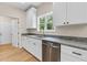 Well-lit kitchen with white cabinetry, granite counters, stainless steel appliances, and a large window at 5224 W Mountain St, Stone Mountain, GA 30083