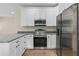 Modern kitchen showcasing stainless steel appliances, granite countertops, and bright white cabinetry at 5224 W Mountain St, Stone Mountain, GA 30083