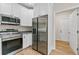 Close-up of a modern kitchen with stainless appliances, granite counters, and bright white cabinets at 5224 W Mountain St, Stone Mountain, GA 30083