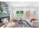 Spacious living room featuring large windows, modern fireplace and decor at 5224 W Mountain St, Stone Mountain, GA 30083
