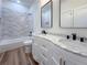 Bathroom with double sinks, granite countertops, modern fixtures, and a separate tiled shower at 5567 Tyree Rd, Winston, GA 30187