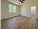 Bedroom with wood floor, ceiling fan, a view of the trees outside, and an ensuite bathroom at 5567 Tyree Rd, Winston, GA 30187