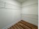 Empty walk-in closet with wood-look flooring and wire shelving for plenty of storage at 5567 Tyree Rd, Winston, GA 30187