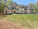 Stunning two-story home featuring a manicured lawn, symmetrical design, and impeccable curb appeal at 5567 Tyree Rd, Winston, GA 30187