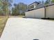 Spacious two-car garage with a concrete driveway, set against a lush, wooded backdrop at 5567 Tyree Rd, Winston, GA 30187
