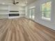 Open living area with hardwood floors, large windows, and built-in shelving and fireplace at 5567 Tyree Rd, Winston, GA 30187