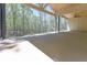 Spacious covered patio with an exposed beam wood ceiling and a view of the wooded backyard at 5567 Tyree Rd, Winston, GA 30187