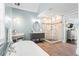 Bathroom featuring a soaking tub and a glass enclosed shower with neutral paint and stone tile at 6360 Spinnaker Ln, Alpharetta, GA 30005
