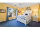 Bright bedroom with yellow walls, a comfortable bed, and a view of the surrounding neighborhood at 6360 Spinnaker Ln, Alpharetta, GA 30005