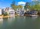 Beautiful lakefront homes with private docks surrounded by stunning water views and mature trees at 6360 Spinnaker Ln, Alpharetta, GA 30005