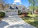 Charming home featuring a well-manicured lawn, mature landscaping, and a two-car garage at 6360 Spinnaker Ln, Alpharetta, GA 30005