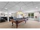 Finished basement game room featuring a pool table, seating, and walkout access at 6360 Spinnaker Ln, Alpharetta, GA 30005