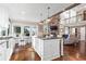 Open-concept kitchen with a central island and a view of the living room and outdoor scenery at 6360 Spinnaker Ln, Alpharetta, GA 30005