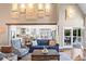 Bright living room with an open floor plan, exposed beam, and access to an outdoor patio at 6360 Spinnaker Ln, Alpharetta, GA 30005