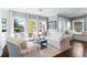 Cozy living room with large windows offering stunning lake views, comfortable seating, and stylish decor at 6360 Spinnaker Ln, Alpharetta, GA 30005