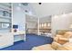 Upstairs loft featuring a sitting area, a desk, hardwood floors, and vaulted ceilings at 6360 Spinnaker Ln, Alpharetta, GA 30005