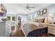 Spacious main bedroom with hardwood floors, a king bed, a sitting area, and a walk-in closet at 6360 Spinnaker Ln, Alpharetta, GA 30005