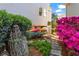 Charming side yard with stone pathway, vibrant flowers, and storage for kayaks at 6360 Spinnaker Ln, Alpharetta, GA 30005