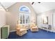 Comfortable sitting room with cozy chairs, a large arched window, and neutral paint at 6360 Spinnaker Ln, Alpharetta, GA 30005