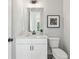 Compact bathroom featuring a white vanity, modern fixtures, and clean design at 1140 Hubbard Sw St, Atlanta, GA 30310