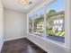 Bright room featuring a large window with a suburban street view and wood floors at 1140 Hubbard Sw St, Atlanta, GA 30310
